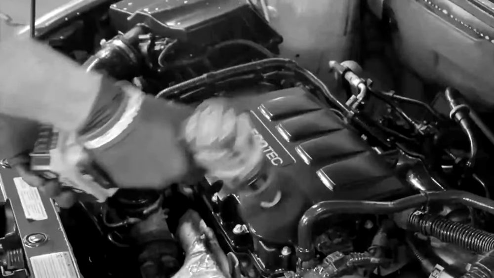 Brushing out an engine bay during an exterior detail