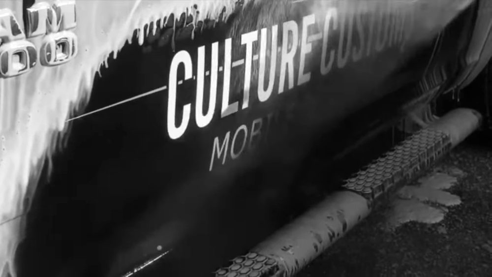 Foam running down the side of a Culture Customs truck during a hand wash